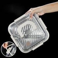 Stainless steel lunch box with foldable handle and clear leakproof lid.