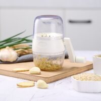 Compact peanut and dried fruit crusher tool for kitchen use – handheld gray and white design