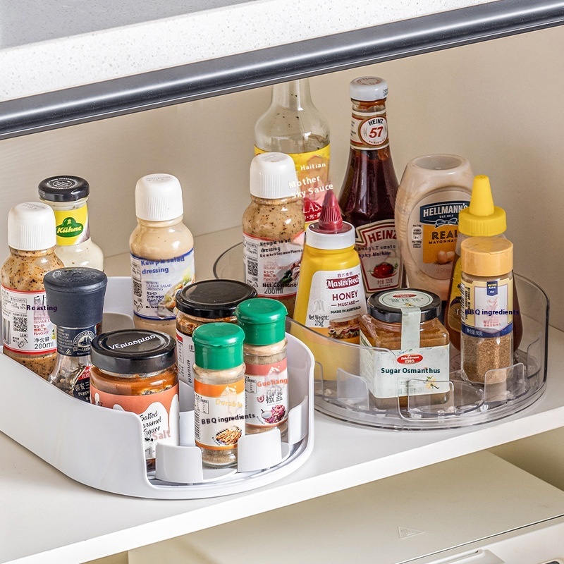 TextPlastic 360 degree rotation storage tray for refrigerator shelf holding seasoning bottles with raised edges and handles.